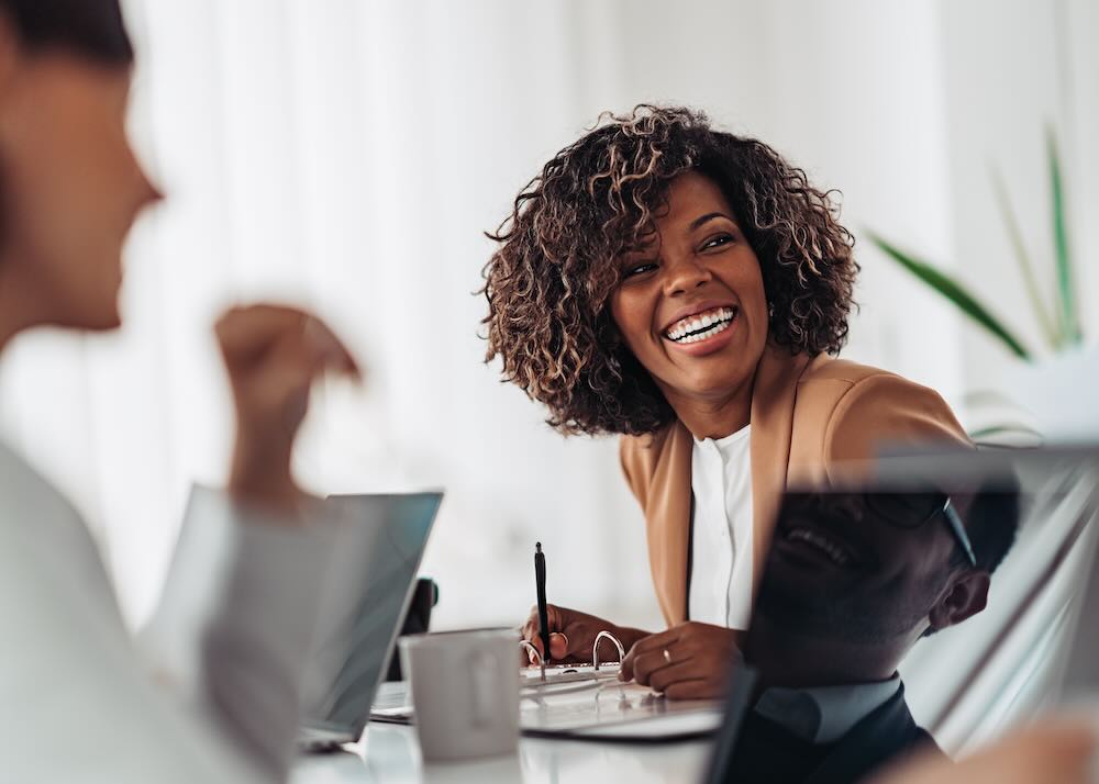 Female executive smiling to someone off camera 