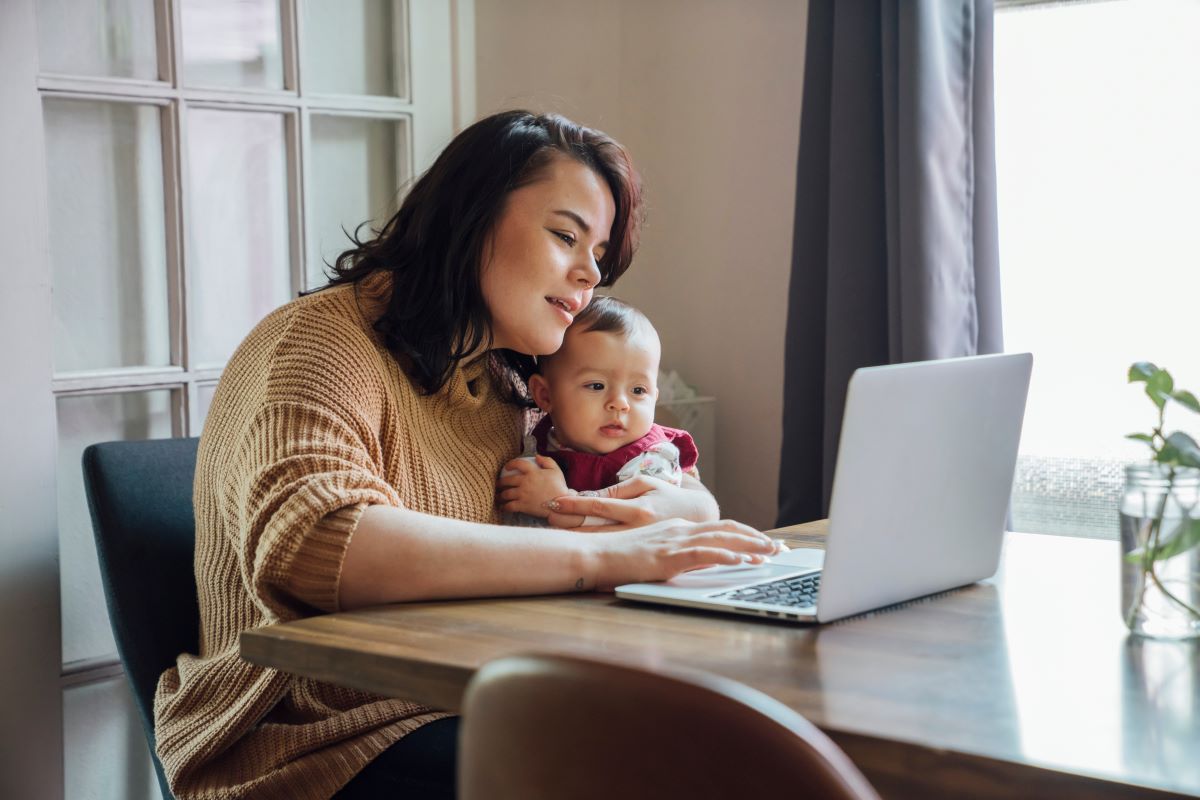 Woman with a young child looking at a computer